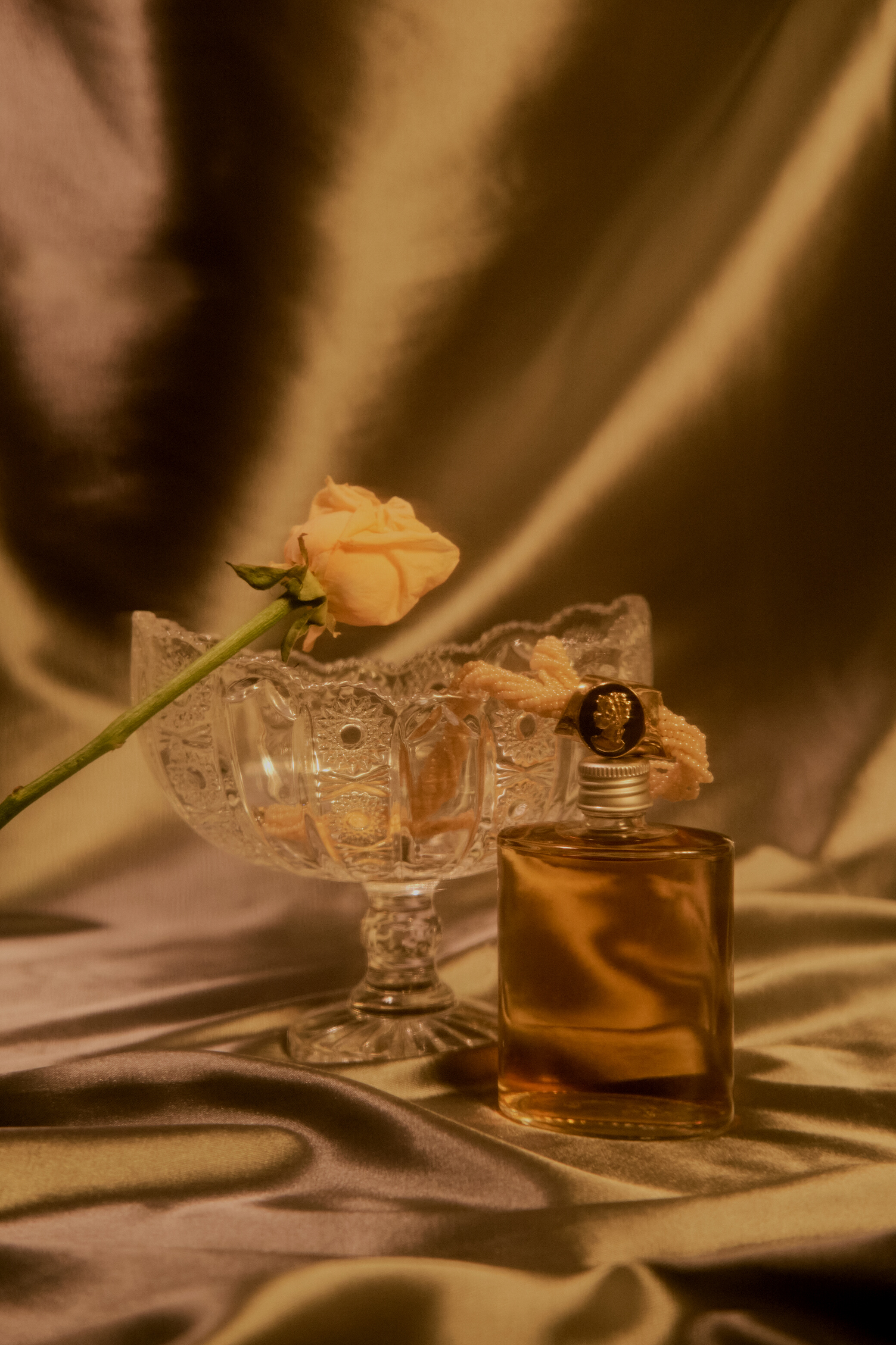 Perfume Bottle on Light Silk Background